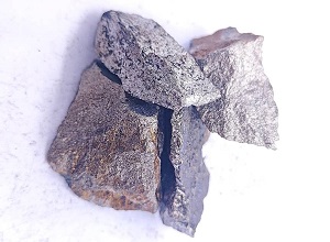 Close up appearance of high carbon ferro manganese 75% lump showing surface texture and shape