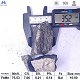 High carbon ferro manganese 75% lump with ruler for size reference and chemical specifications table, top-down view angle 1