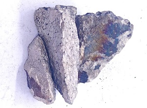 Close up appearance of mid carbon ferro manganese 75% lump showing surface texture and shape