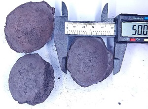 Silicon carbide briquette 75% appearance showing typical pillow-shaped briquette, dark color, smooth surface texture